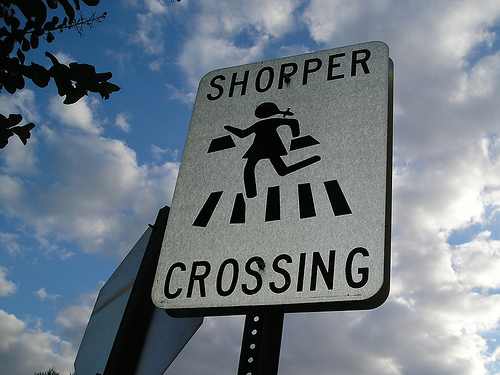 Shopper crossing sign to highlight media budgets for advertisers