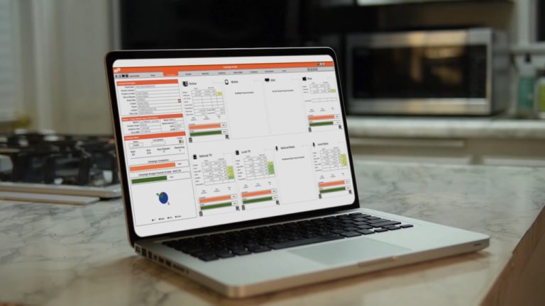 Laptop on kitchen counter with reporting software running