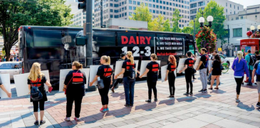 downtown city with be fair be vegan ad on bus