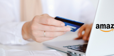 Woman holding credit card and entering information on laptop