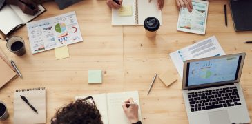 Top-down shot of marketing experts collaborating at a table