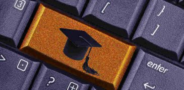 computer keyboard close up with graduation cap as a key