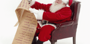 Santa sitting on chair while looking at naughty or nice list